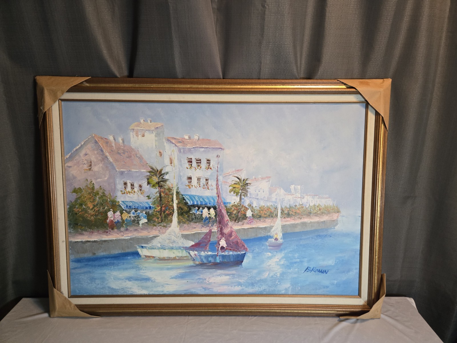 Impressionist oil painting by J. Brown features boats moored in a seaside